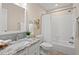 Bright bathroom with modern granite countertop, white cabinets, shower, and tub at 1504 Haventree Rd, Durham, NC 27713