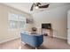 Bedroom features a comfortable sofa, hardwood chair, and mounted television at 1504 Haventree Rd, Durham, NC 27713