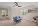 Cozy bedroom featuring blue sofa, hardwood chair, and unique decor at 1504 Haventree Rd, Durham, NC 27713