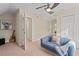 Cozy bedroom featuring carpet floors, ceiling fan, closet, and seating at 1504 Haventree Rd, Durham, NC 27713