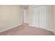 Spacious carpeted bedroom featuring a large double door closet at 1504 Haventree Rd, Durham, NC 27713