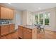 Open kitchen with granite island, stainless steel appliances, and bright breakfast area at 1504 Haventree Rd, Durham, NC 27713