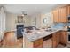 Kitchen with breakfast bar, stainless appliances, and adjacent living space at 1504 Haventree Rd, Durham, NC 27713