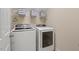 Bright laundry room features washer and dryer on a tile floor at 1504 Haventree Rd, Durham, NC 27713