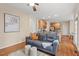 Open living room features a gray sofa, hardwood floors, and connects to the kitchen at 1504 Haventree Rd, Durham, NC 27713