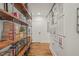 Hallway with bookshelf and hardwood floors, showcasing artistic decor and contemporary design at 1535 Caraleigh Mills Ct # 210, Raleigh, NC 27603