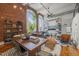 Stylish living room with exposed brick, large windows, and an open floor plan showcasing natural light at 1535 Caraleigh Mills Ct # 210, Raleigh, NC 27603