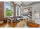 Inviting living room with exposed brick, large windows, and a stylish shelving unit at 1535 Caraleigh Mills Ct # 210, Raleigh, NC 27603