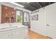 Bright, open living area showcasing kitchen, living room, and exposed brick accent wall at 1535 Caraleigh Mills Ct # 210, Raleigh, NC 27603