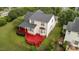 Aerial view of the home shows a large lot, new roof, and red deck with lots of room to entertain at 1604 Carnation Dr, Durham, NC 27703