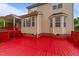 Back of house with bay window and a red painted wood deck at 1604 Carnation Dr, Durham, NC 27703
