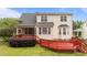 Home's red back deck offers a great place for outdoor seating and entertaining with views of the backyard at 1604 Carnation Dr, Durham, NC 27703