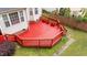 Aerial view of back yard with red painted wood deck and green grass at 1604 Carnation Dr, Durham, NC 27703