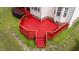 Aerial view of the spacious red back deck with wooden railings, perfect for outdoor entertaining at 1604 Carnation Dr, Durham, NC 27703