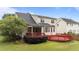 Spacious backyard features a covered porch and a large red deck, perfect for outdoor gatherings at 1604 Carnation Dr, Durham, NC 27703