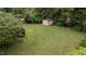 The home features a large backyard with mature trees, storage shed and a basketball hoop at 1604 Carnation Dr, Durham, NC 27703