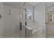 Bright bathroom featuring a glass shower door, soaking tub and window at 1604 Carnation Dr, Durham, NC 27703