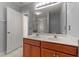 Bright bathroom with double sinks, spacious vanity, and large mirror with modern lighting at 1604 Carnation Dr, Durham, NC 27703
