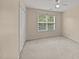 Bright bedroom with large window, plush carpeting, and closet space at 1604 Carnation Dr, Durham, NC 27703