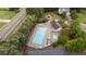 Aerial view shows community pool with ample lounge seating and parking surrounded by mature trees at 1604 Carnation Dr, Durham, NC 27703