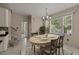 Charming dining area with an oval table set for four, with natural light and views at 1604 Carnation Dr, Durham, NC 27703