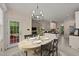 Open-concept dining area with view to living room, kitchen, and outdoor space at 1604 Carnation Dr, Durham, NC 27703