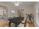 Cozy dining room features hardwood floors, chair rail molding, and decorative furnishings, open to kitchen at 1604 Carnation Dr, Durham, NC 27703