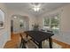 Traditional dining room with wood floors, wainscoting, a ceiling fan, and natural light from large windows at 1604 Carnation Dr, Durham, NC 27703