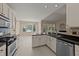 Bright kitchen boasts stainless appliances, tile backsplash, an island with sink, and an adjacent dining area at 1604 Carnation Dr, Durham, NC 27703
