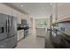 Well-lit kitchen with stainless appliances, ample cabinet space and backsplash at 1604 Carnation Dr, Durham, NC 27703