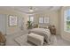Inviting main bedroom features neutral tones, a tray ceiling, ceiling fan, ensuite bath, and plush carpeting at 1604 Carnation Dr, Durham, NC 27703