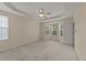 Expansive primary bedroom featuring neutral paint, carpet, a ceiling fan, tray ceiling, and natural light at 1604 Carnation Dr, Durham, NC 27703