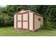 The backyard features a convenient and well-maintained storage shed with charming details at 1604 Carnation Dr, Durham, NC 27703