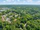 Sprawling aerial shot of homes nestled among abundant trees, providing a tranquil and scenic neighborhood view at 1605 Valley Run, Durham, NC 27707