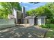 Back exterior view shows back deck, sliding glass door and parking area at 1605 Valley Run, Durham, NC 27707