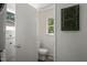This half bathroom has white wainscoting and a white vanity at 1605 Valley Run, Durham, NC 27707