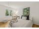 Bright bedroom with a large window that lets in natural light, wooden floors, and a desk at 1605 Valley Run, Durham, NC 27707