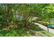 Landscaped front yard leading to a quaint home with a mailbox showing the address number at 1605 Valley Run, Durham, NC 27707