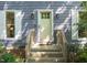 Close-up of the home's front door, showcasing a welcoming entryway with sidelights and a wooden porch at 1605 Valley Run, Durham, NC 27707