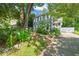 Charming two-story home with light blue siding, white trim, and a landscaped front yard surrounded by mature trees at 1605 Valley Run, Durham, NC 27707