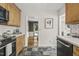 Bright kitchen features stainless appliances, white subway tile backsplash, light wood cabinets and unique flooring at 1605 Valley Run, Durham, NC 27707