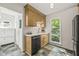 This kitchen boasts light wood cabinets, stainless steel dishwasher, white counters and subway tile backsplash at 1605 Valley Run, Durham, NC 27707