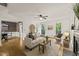 Cozy living room features hardwood floors, neutral decor, a ceiling fan, and ample natural light at 1605 Valley Run, Durham, NC 27707