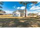 Exterior of a white home showcasing a backyard with a large tree and blue sky at 162 Farmstead Ct, Wendell, NC 27591