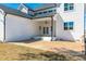 White home exterior featuring a brick patio, backyard, covered porch, and double doors at 162 Farmstead Ct, Wendell, NC 27591