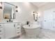 Bright bathroom showcasing double vanity, soaking tub, modern fixtures, and a marble-tiled floor at 162 Farmstead Ct, Wendell, NC 27591