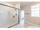 Bathroom featuring marble floors, a glass enclosed shower and a separate soaking tub at 162 Farmstead Ct, Wendell, NC 27591