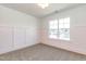 White bedroom featuring modern paneling and a large window overlooking the neighborhood at 162 Farmstead Ct, Wendell, NC 27591