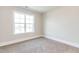 Neutral bedroom featuring a window to the yard and plush carpeting at 162 Farmstead Ct, Wendell, NC 27591