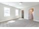 Spacious bedroom with two windows, neutral carpet, and walk-in closet at 162 Farmstead Ct, Wendell, NC 27591